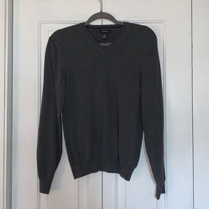 Dark gray v-neck sweater.